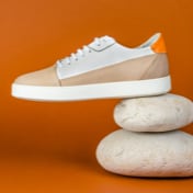 picture of a shoe on it side on top of two rounded rocks